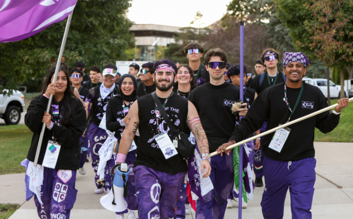 off campus sophs, dressed up in black and purple, walking towards UC hill during oweek.