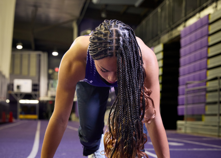 a track athlete posing before running