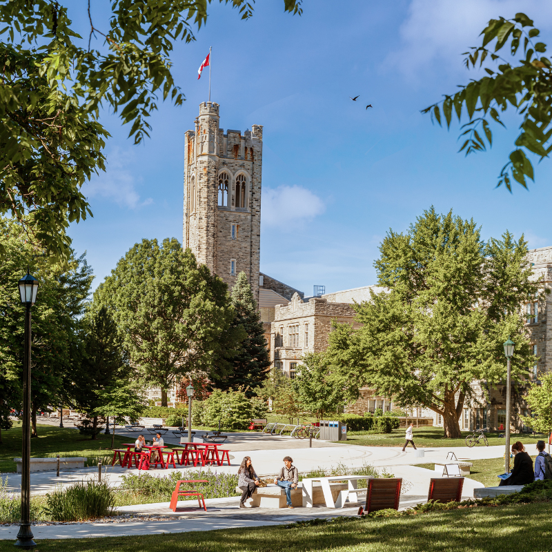 University College tower on a sunny day, with students walking the paths.