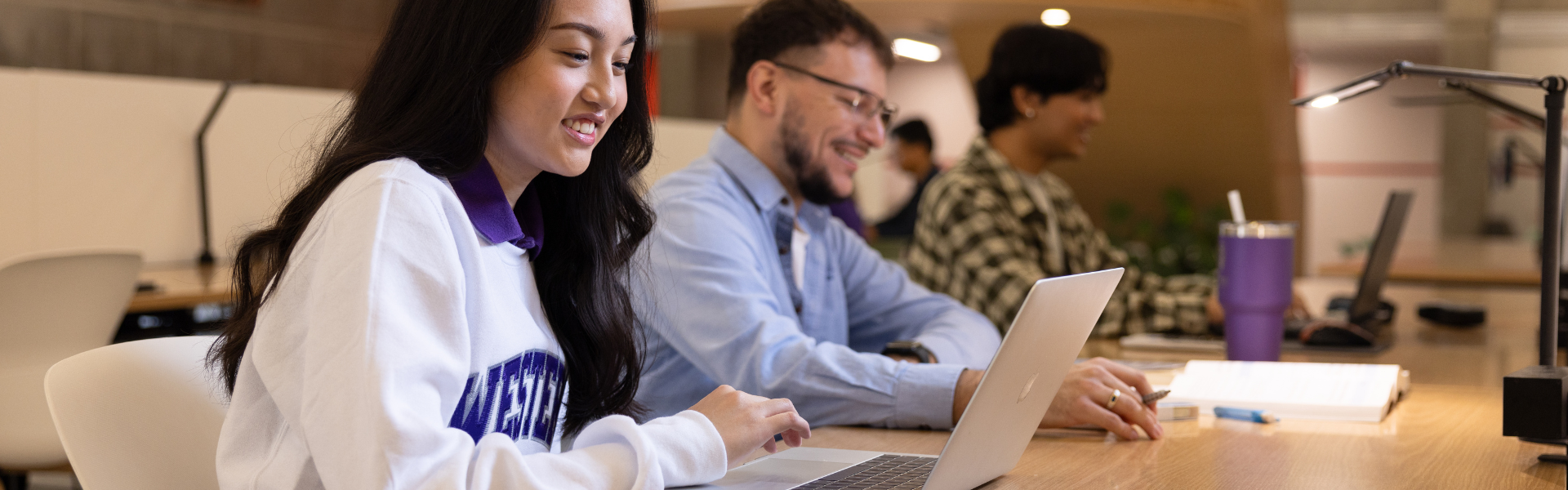 Students studying at a table together in Weldon Library