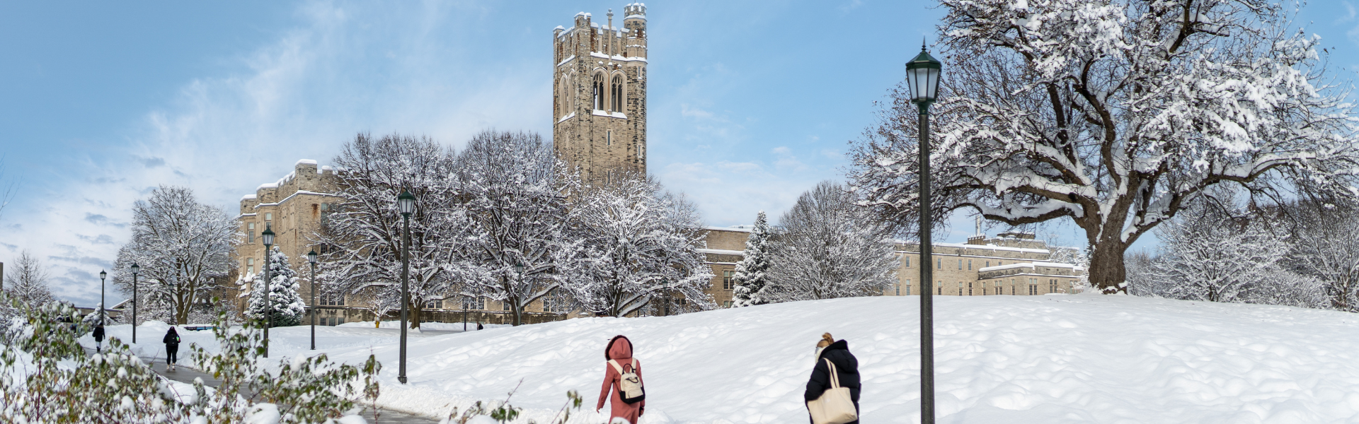 Students walking up UC hill on a snow covered winter day.