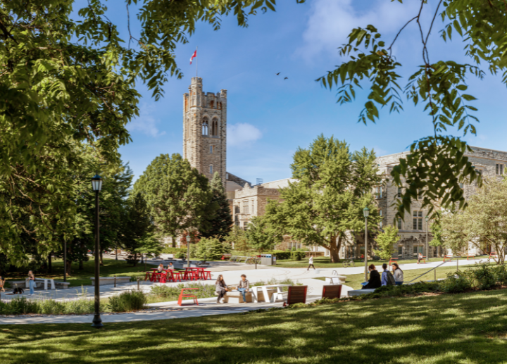 University College tower on a sunny day, with students walking on campus.